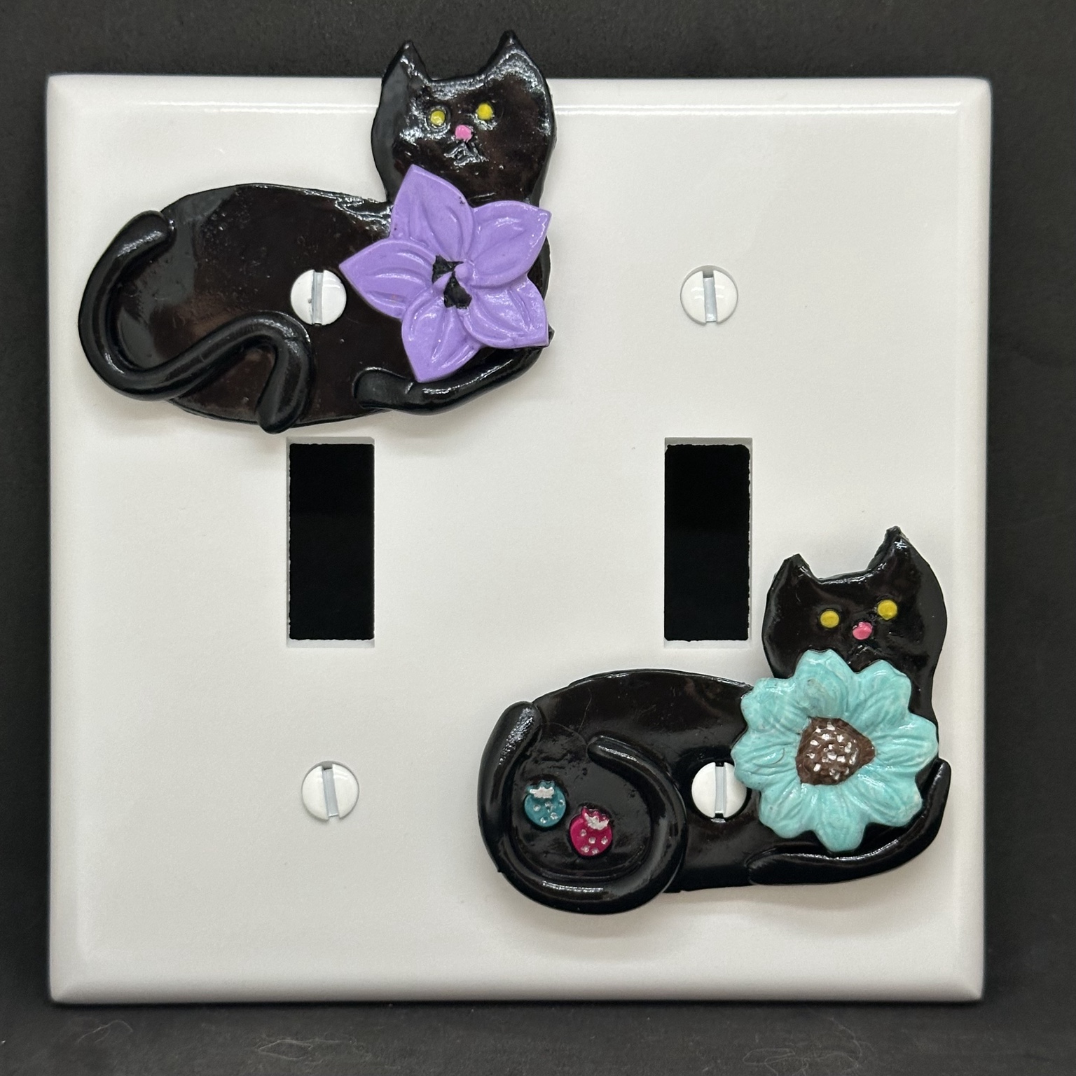 Black cat wall-plate charms with purple and turquoise flowers